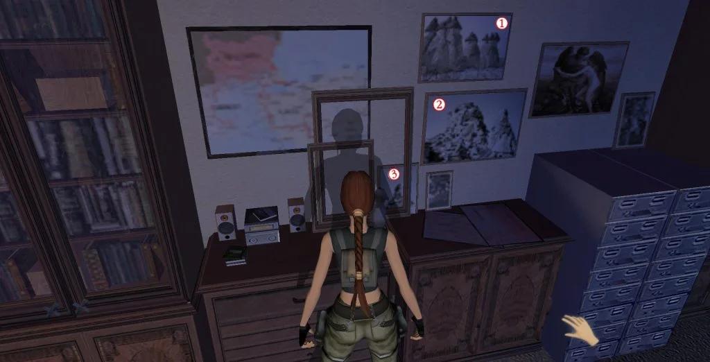 A video game screenshot showing the character Lara Croft in a room with pictures and artifacts on the wall, representing a research or study area.
