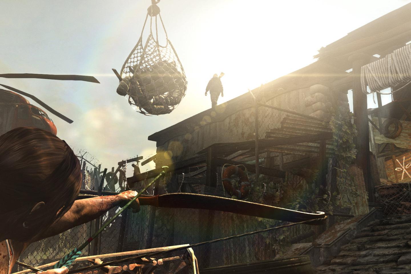 Lara pointing sword toward silhouette of person standing on rooftop while supplies hang in fishing net above their heads. 