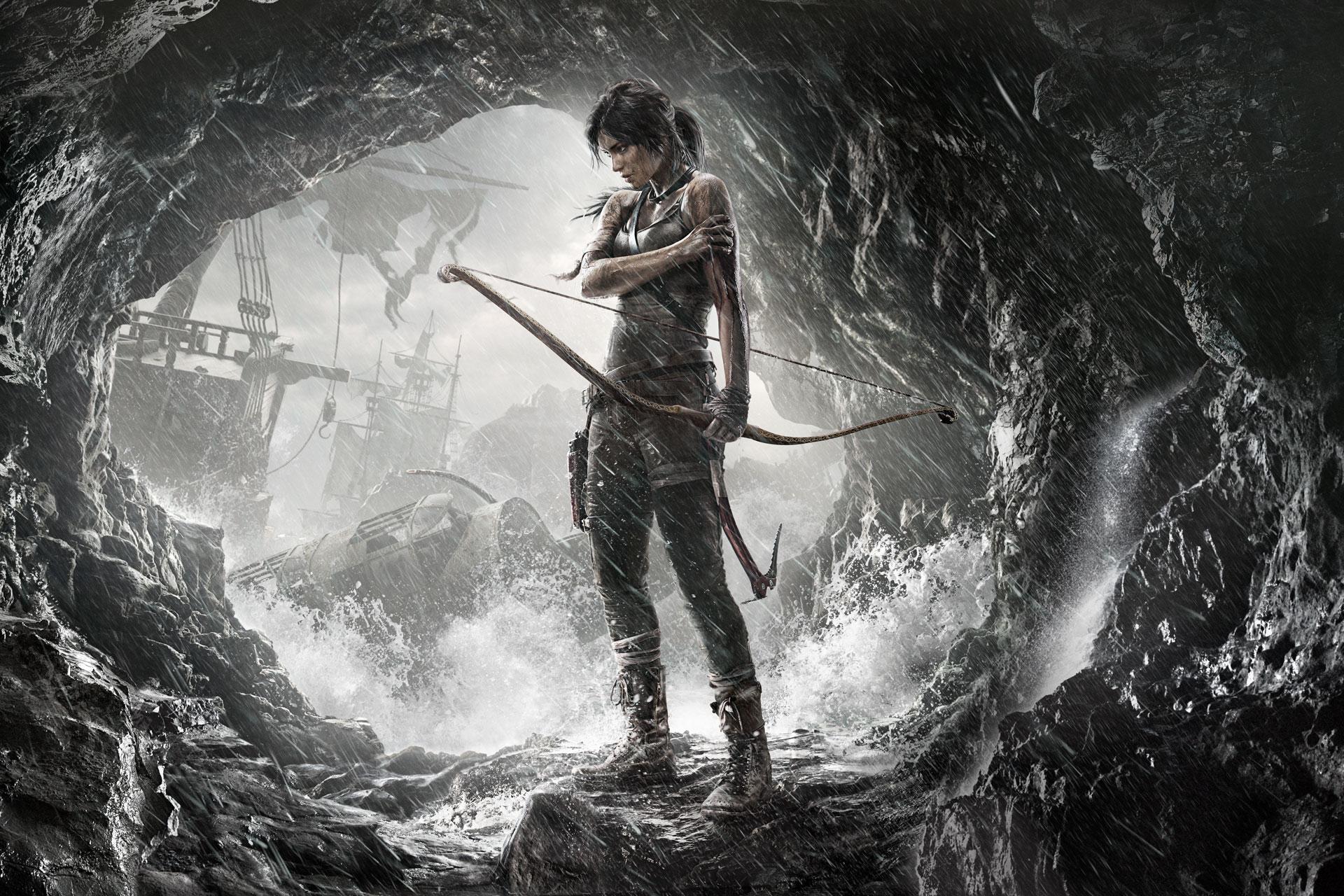 Lara Croft standing in a dark sea cave in Tomb Raider (2013).