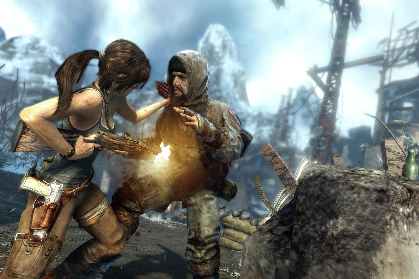 Lara firing gun at man wearing hood reaching for her.