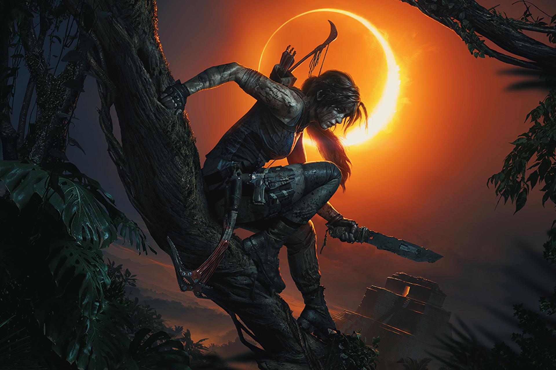 Lara Croft sitting on a tree in front of an eclipse with a glowing orange sky in the background.