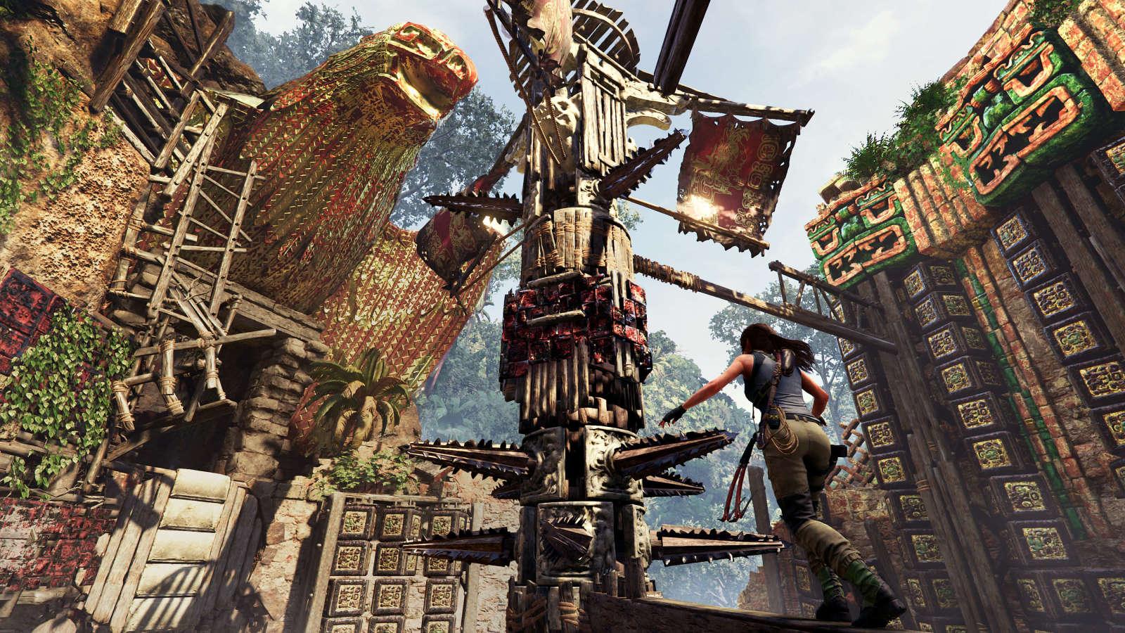 Lara Croft climbing an intricate wooden structure adorned with colorful tribal decorations in a dense, ruin-filled jungle setting.