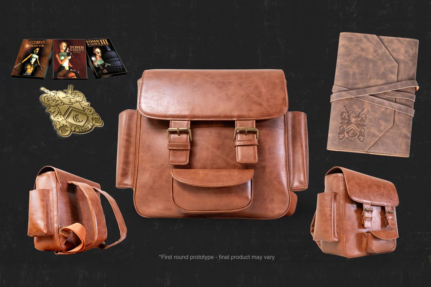 A product image depicting a replica of Lara Croft's backpack, a leather journal, and Tomb Raider game cover-themed collectible pins.
