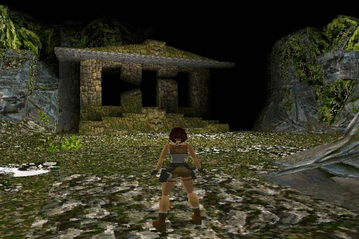 Lara looking at mossy tomb