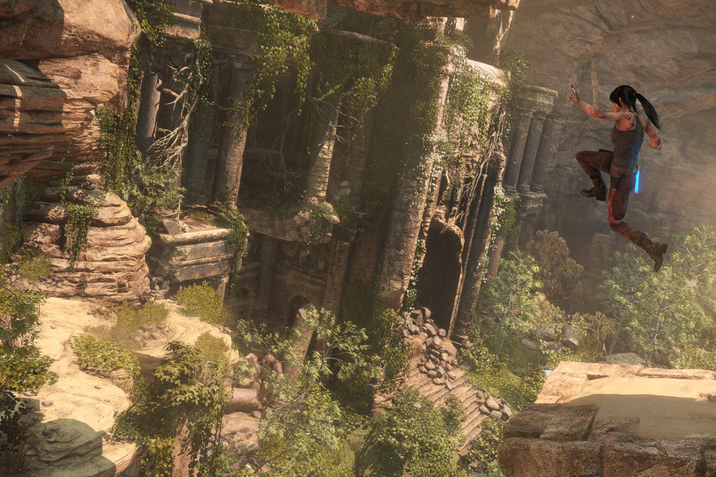 Dynamic action shot from a Tomb Raider game showing Lara Croft mid-leap across a vast canyon with ancient ruins and lush greenery in the background.