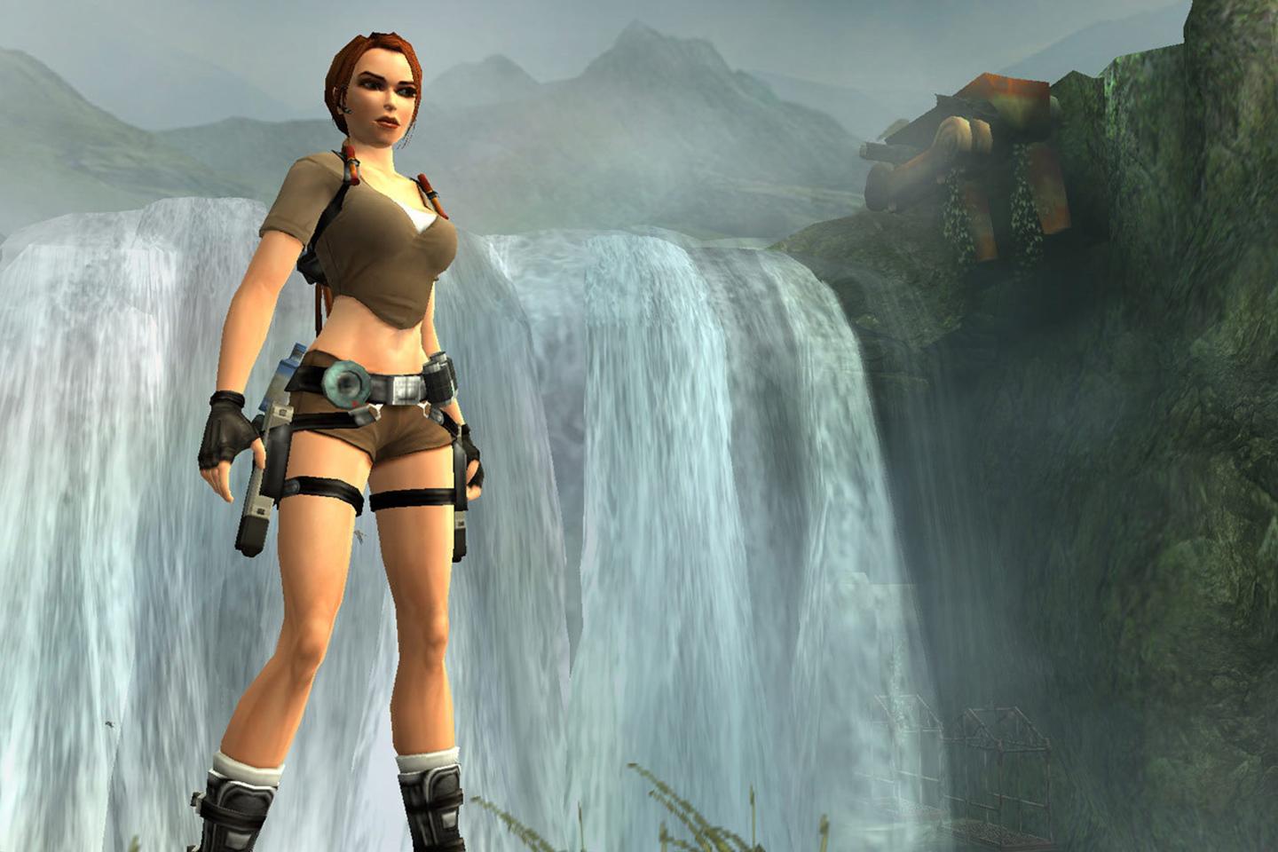 Lara standing in front of waterfall facing the camera.