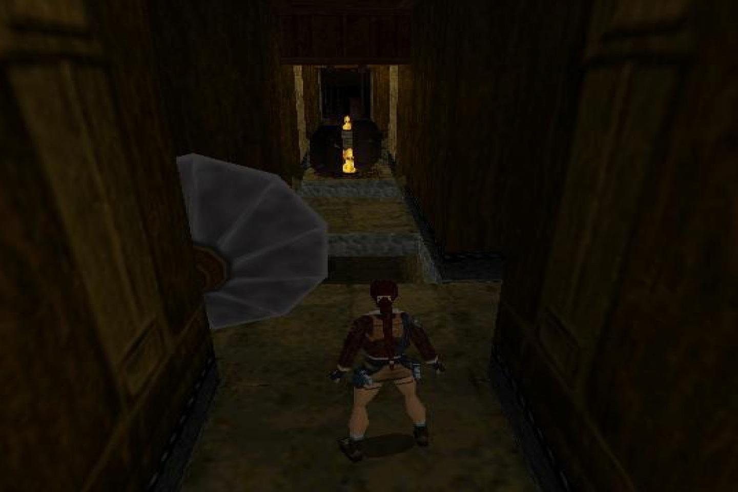 Lara in dark hallway looking toward door