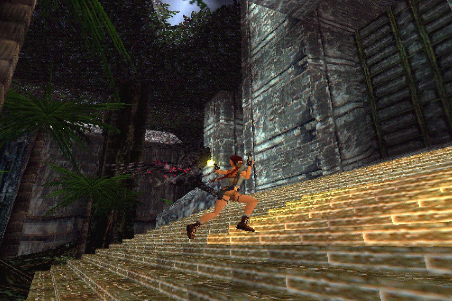 An action shot of Lara in an orange top and brown shorts running up a stone staircase in a jungle setting with ancient ruins and pink flowering plants.