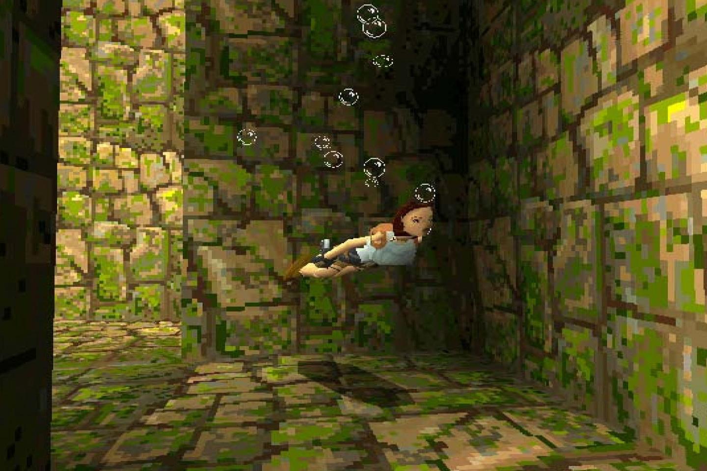 Lara floating among bubbles in a mossy, rock-walled tomb.