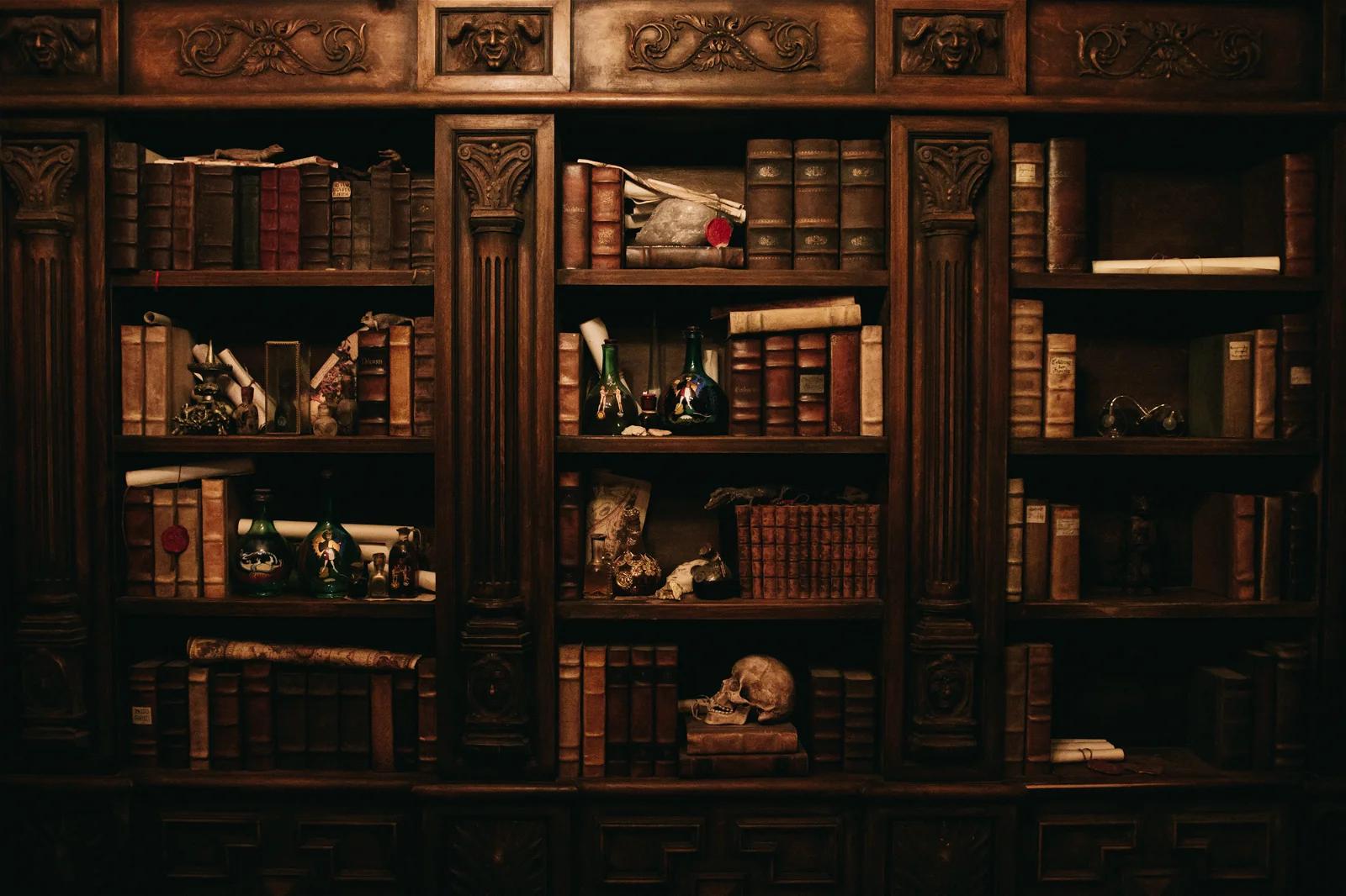 A photo of an old-fashioned wooden bookshelf filled with various antique books, scrolls, and objects, creating a vintage library atmosphere.