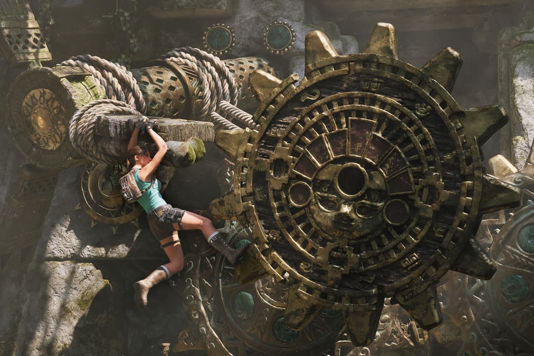Lara Croft climbs a massive ancient gear mechanism inside a temple, navigating ropes, stonework, and intricate machinery.