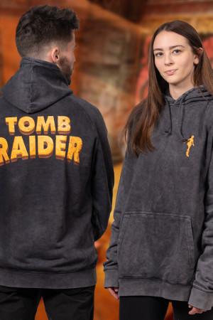 The Tomb Raider Play For Sport Hoodie, a black tie-dyed pullover feat. a silhouette of Lara Croft embroidered on the front, and the game’s logo printed on the back.