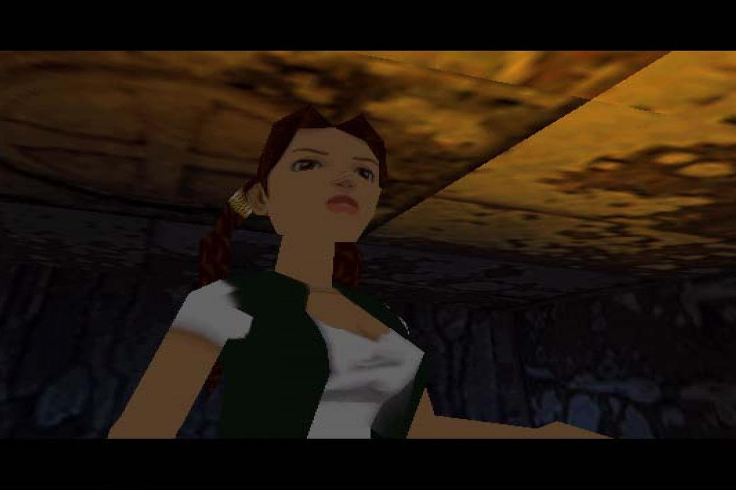 Lara wearing white shirt and green vest.