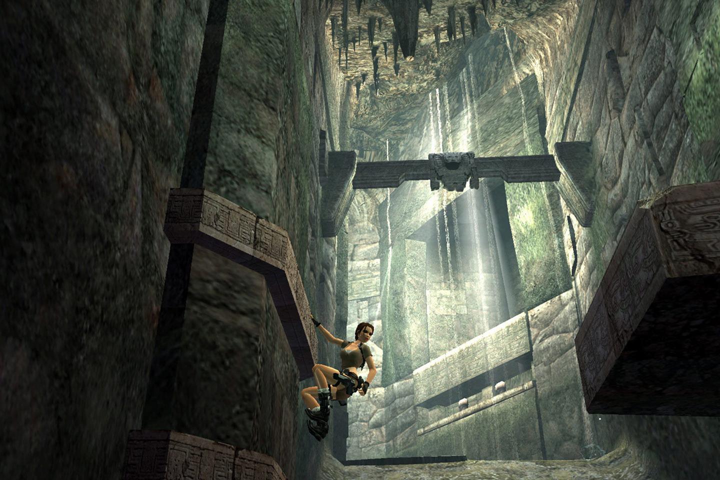 Lara climbing tomb wall looking behind her.