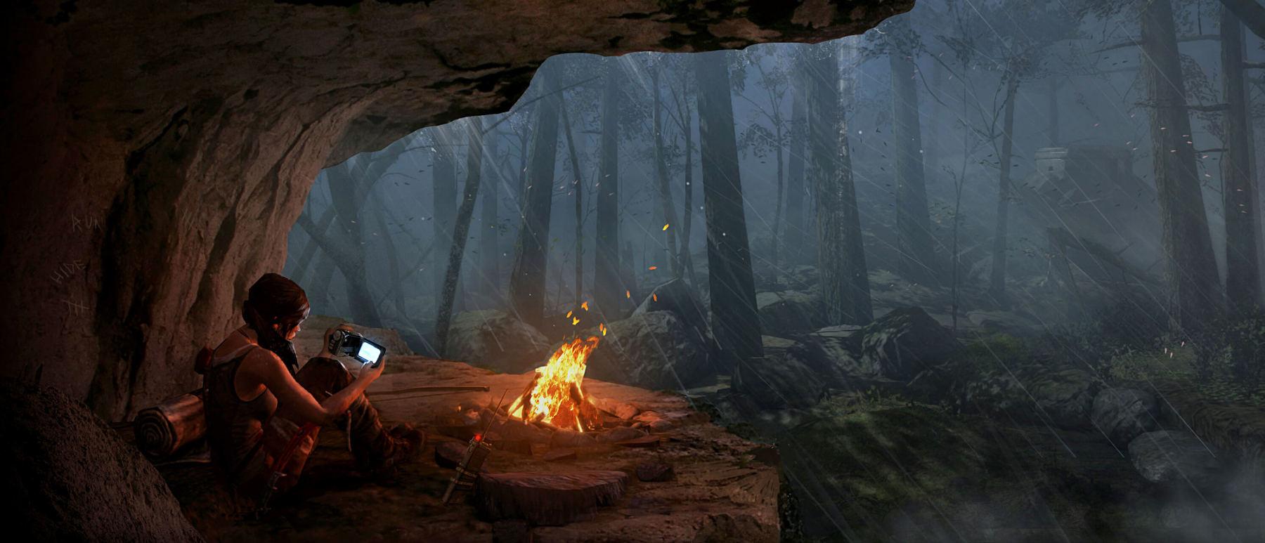 A solitary Lara sits by a campfire inside a cave, gazing at a tablet, with a dense, misty forest visible in the cave's mouth.
